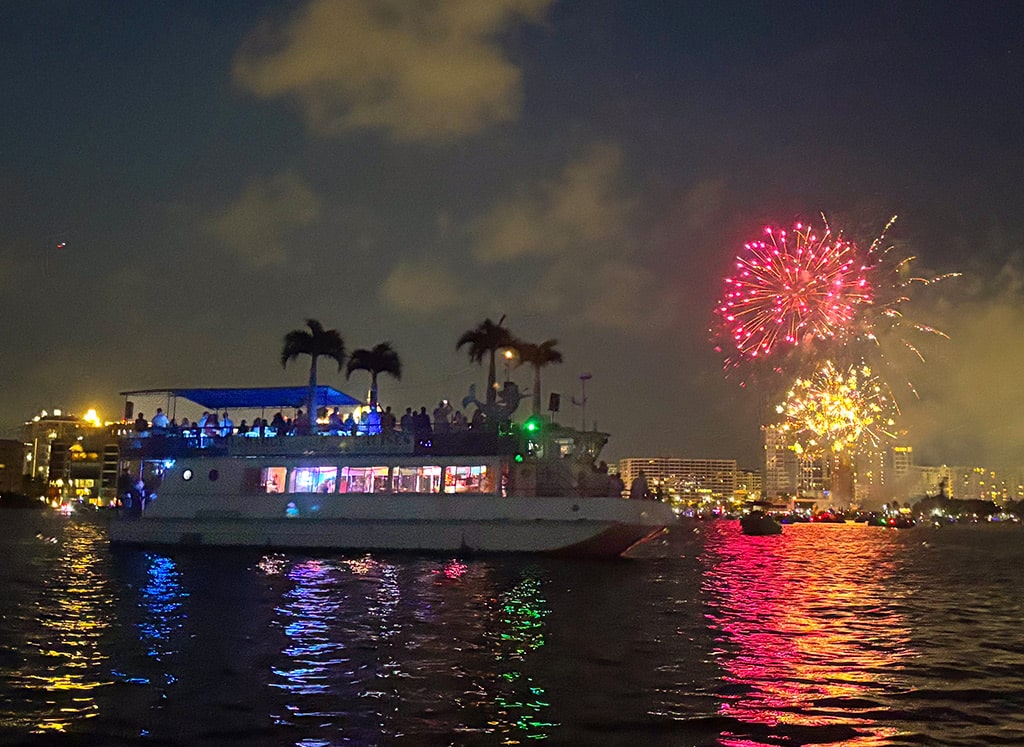 Fireworks over water during a 4th of july cruise on Sarasota Bay