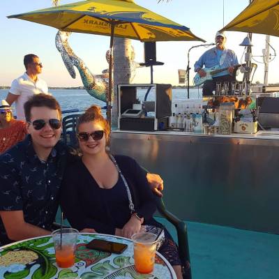 a woman sitting at a table with an umbrella