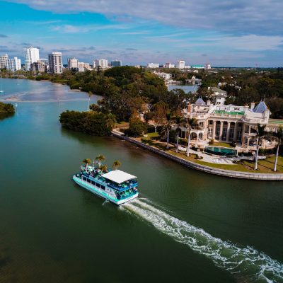 a small boat in a body of water with a city in the background