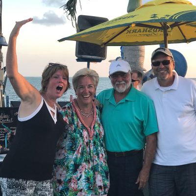 a person standing in front of a group of people posing for the camera