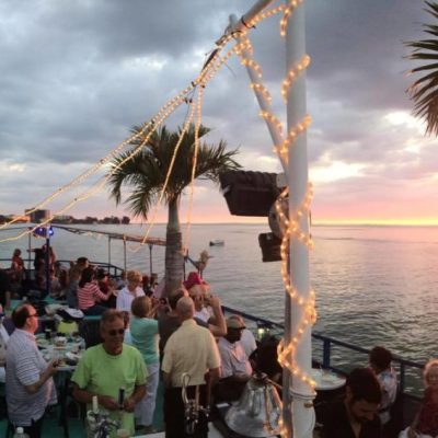 a group of people on a beach with a palm tree