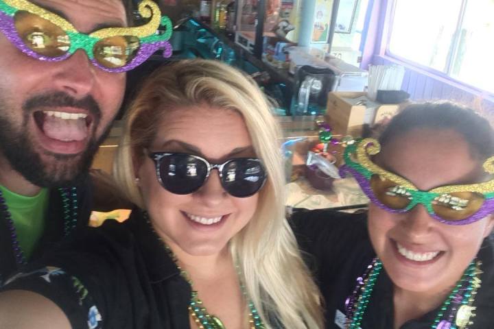 a woman wearing sunglasses posing for the camera