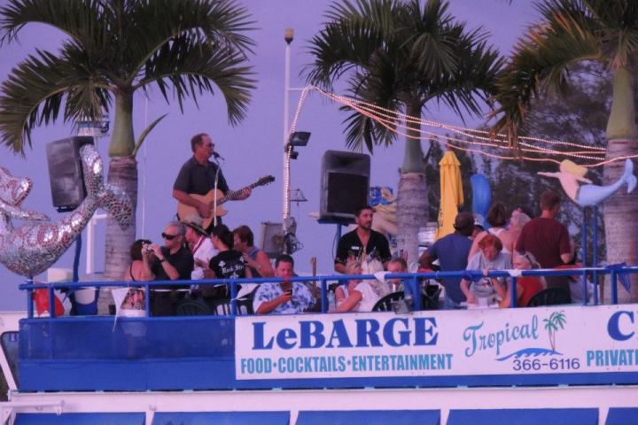 a group of people in front of a palm tree