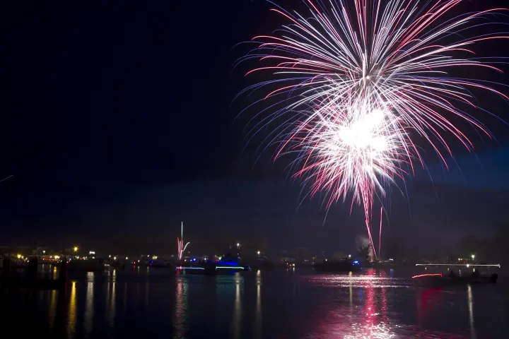fireworks in the night sky over a body of water