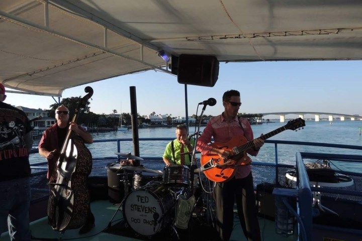 a group of people standing on a boat